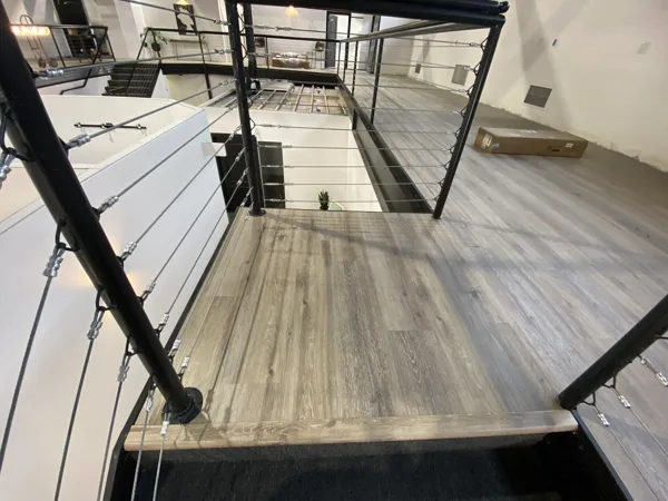 Plank layout and fitted edges around the railing posts and landing.
