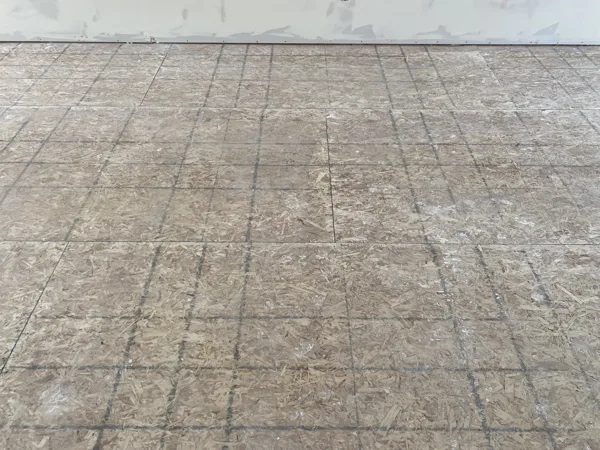 A closer look at the exposed subfloor panels before installation.