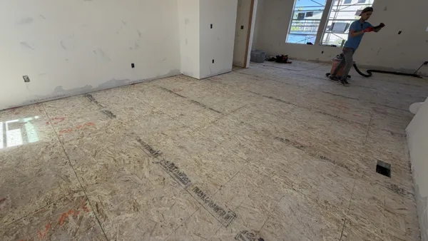A wide view shows the exposed surface from one end of the room to the other.