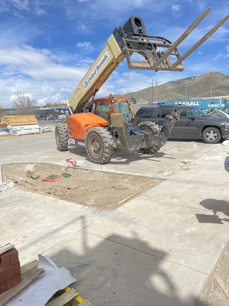 Equipment and crew activity outside the buildings during construction.