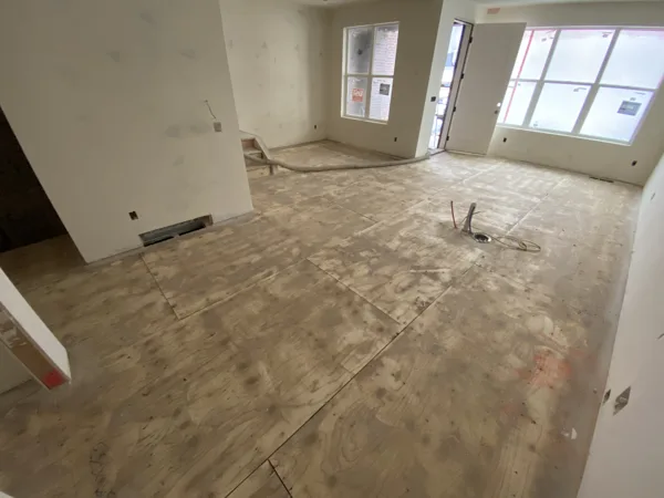 An exposed subfloor in the unfinished interior before flooring goes down.