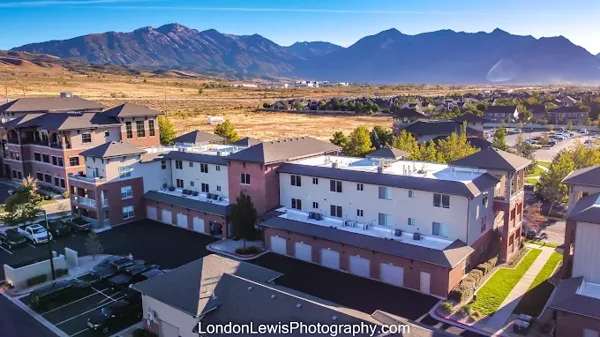 An aerial community view with mountains in the background.