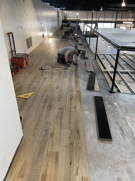 A view of the LVP installation work, finished areas or flooring details at The Beauty Stop.