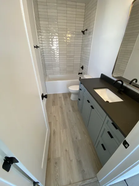 Flooring follows the vanity and adjoining doorway.