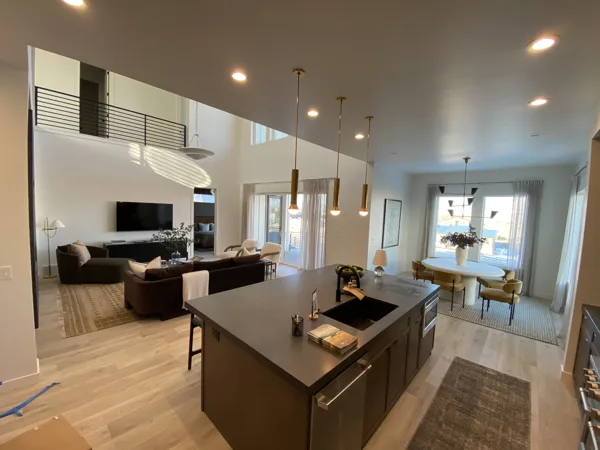 Continuous plank flooring around the kitchen island and dining area.