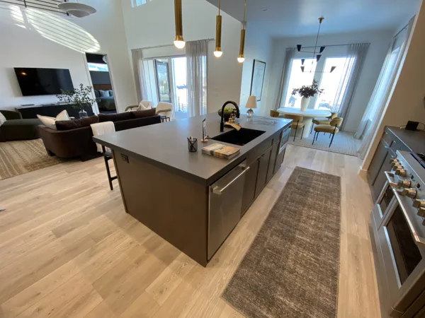 Laminate flooring connecting the kitchen and living area at The Basin