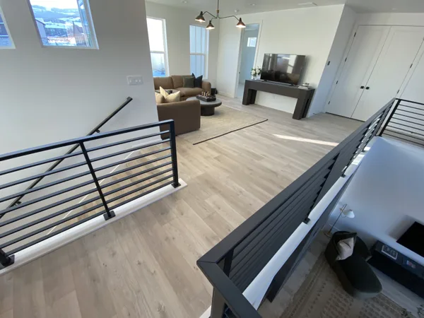Laminate across the upper room and adjacent stair railing.