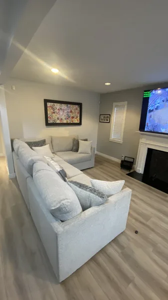 Wood-look plank flooring through the bungalow’s living area and adjoining kitchen.