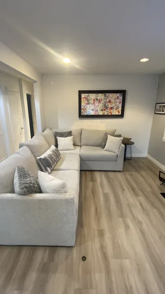Wood-look plank flooring through the bungalow’s living area and adjoining kitchen.