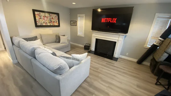 Wood-look plank flooring through the bungalow’s living area and adjoining kitchen.