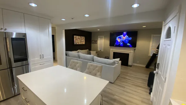 Wood-look plank flooring through the bungalow’s living area and adjoining kitchen.