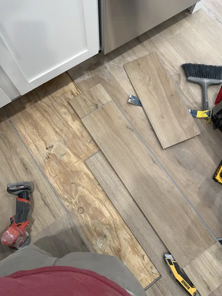 Plank pieces and tools around the vent area during the repair.